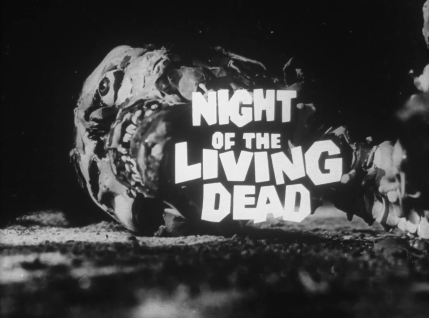 The title card of Night of the Living Dead (1968), white block lettering over a dark, rocky backdrop
